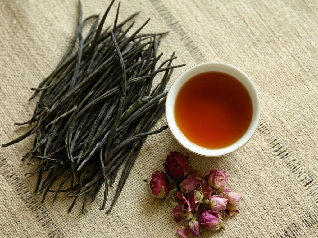 Handmade Ceylon black tea leaves with a cup of amber tea, from Kandy, Sri Lanka