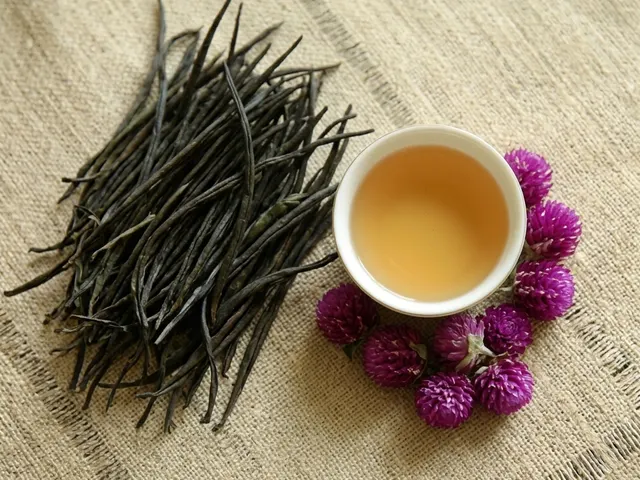 Ceylon golden tips tea leaves with a cup of golden-amber tea, handmade in Kandy, Sri Lanka